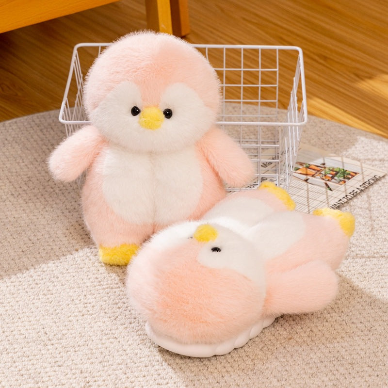 Pink plush penguin toy and a pink penguin slipper on a beige rug beside a wire basket, Pink Full-Heel EU 40-41