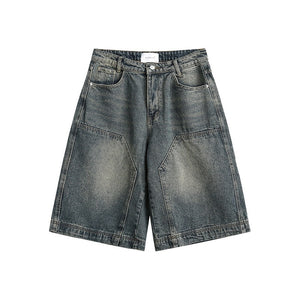 Vintage washed denim shorts folded on a wooden bench beside a tote