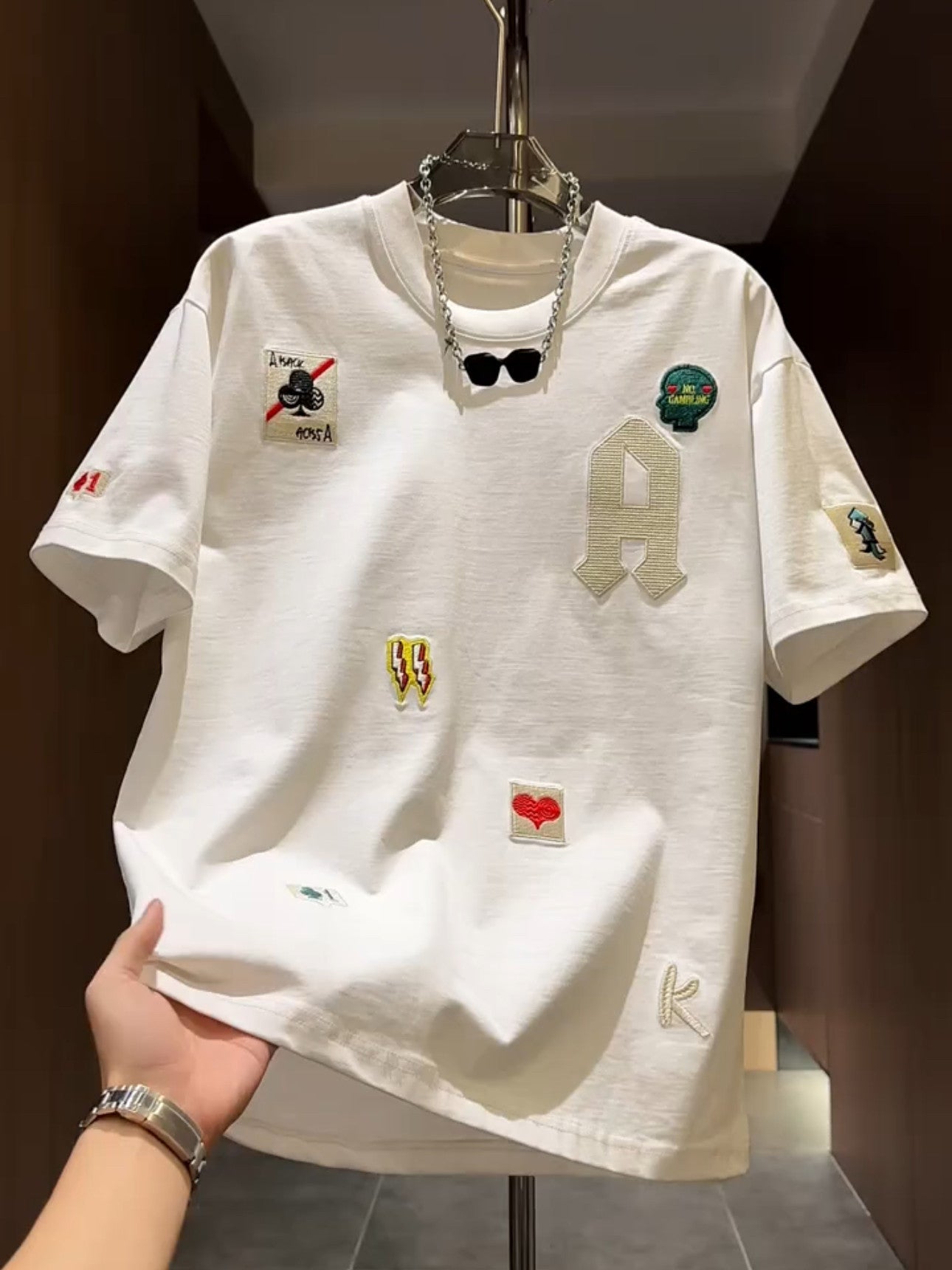 Men's loose fit embroidered patch T-shirt in white with a varsity A letter and sewn on patches