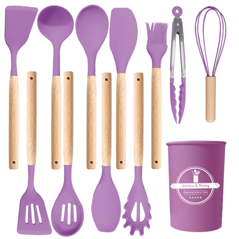 Purple kitchen utensil set shown flat with all twelve pieces and the matching holder