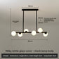 Black pendant light with six milky white glass shades, 80 cm long, 62 cm high, 3-color LED option