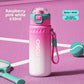 Raspberry pink and white insulated 630ml spray water bottle with a carry rope on a pink court