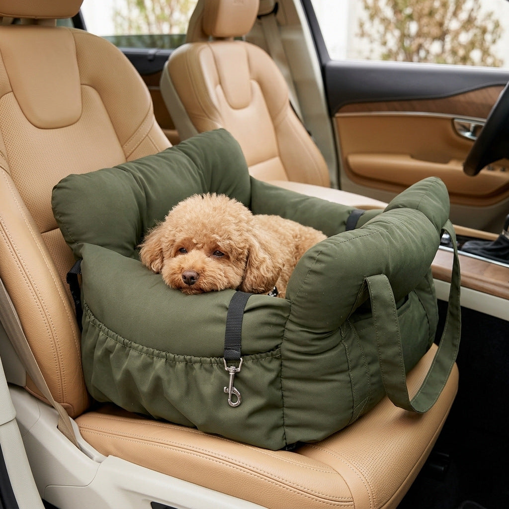 Padded car seat pet bed with raised bolster walls, carry handles and an inner clip with a small dog resting inside on a car
