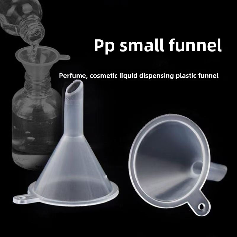 Two translucent plastic mini funnels beside a glass bottle on a black background