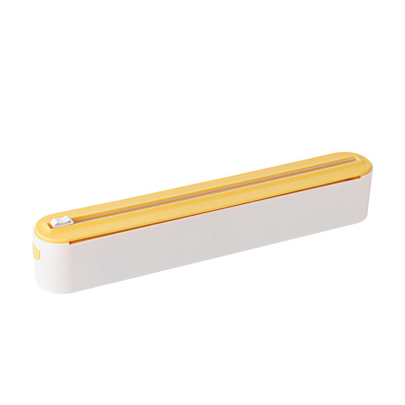 Hand sliding the cutter across the dispenser to tear a clean strip of cling film