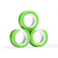 Magnetic fidget rings spread out across a flat surface