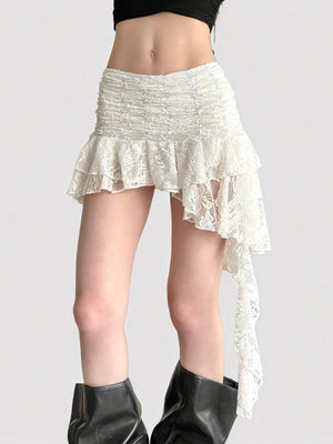 Model in a white floral lace tiered mini skirt with an asymmetric hem and long side tail
