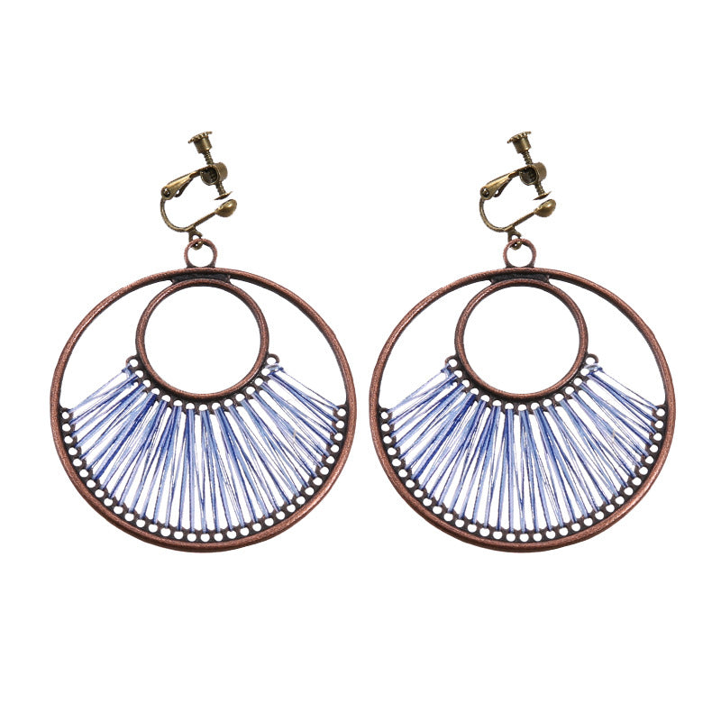 Handmade bohemian clip-on earrings with tassel and bead drop detail, zinc alloy frame, studio shot on white background