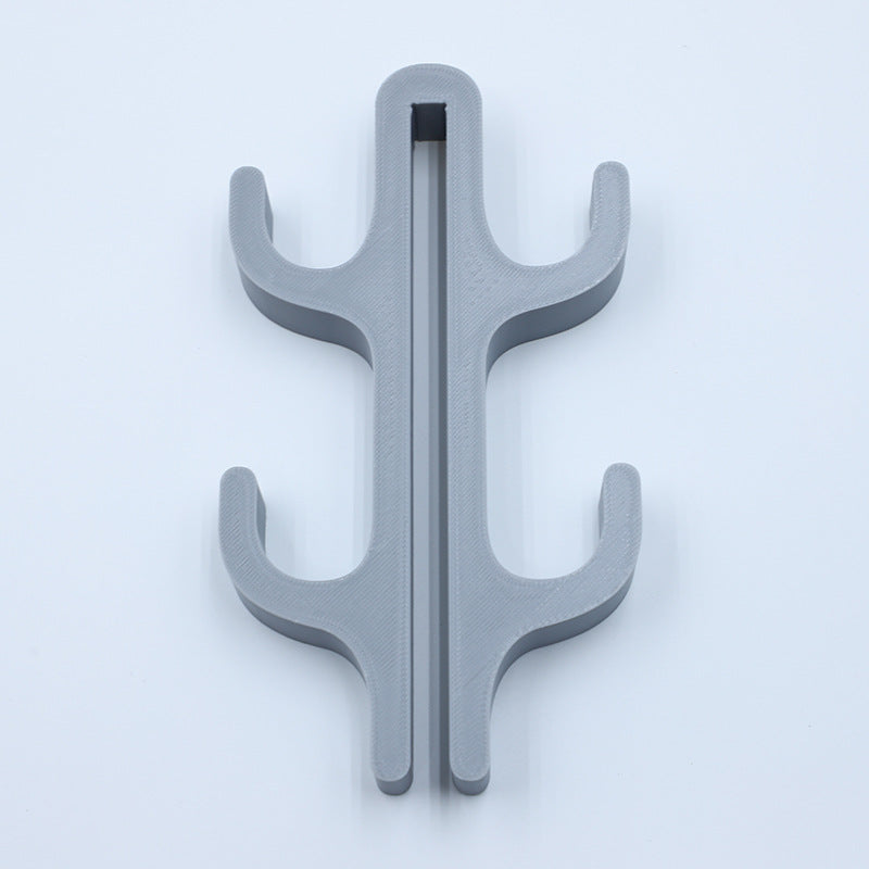 Gray resin four hook with four arms, seen from the front on a light background