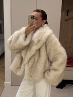 Cream vegan fur short jacket with wide shawl collar worn with white trousers, mirror selfie