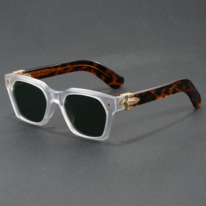 Square sunglasses with a blue to yellow gradient lens and gold temple arrowhead, side view