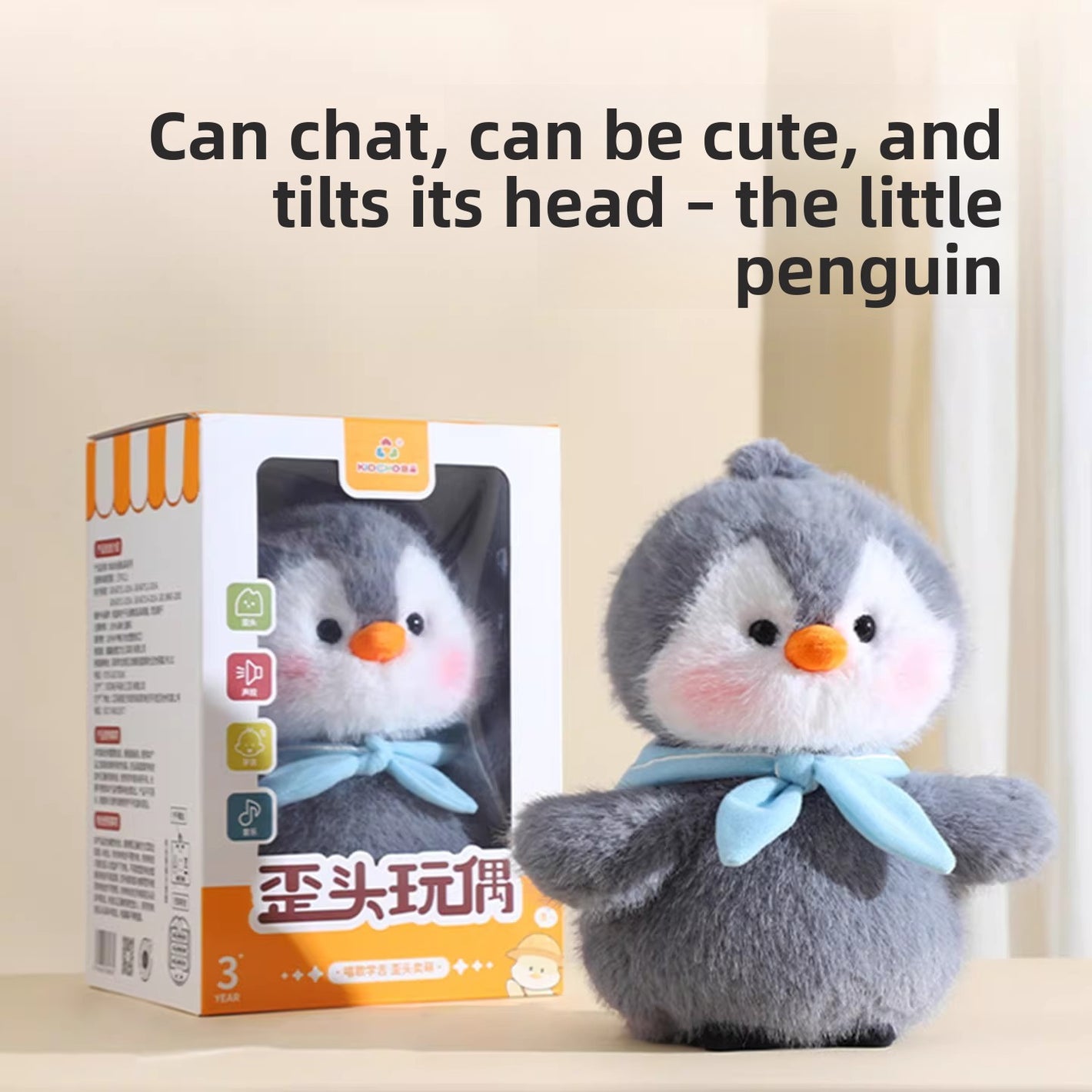 Grey plush penguin toy beside its printed window gift box on a table