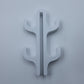 White resin four hook with four arms, seen from the front on a light background