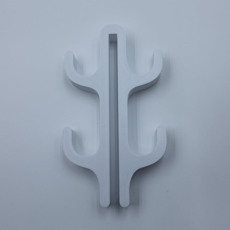 White resin four hook with four arms, seen from the front on a light background