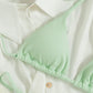 Close up of a mint green ribbed triangle bikini top with halter ties