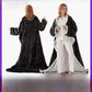 Two women wearing the dark gray wearable blanket with sleeves, one seen from behind in the long cut