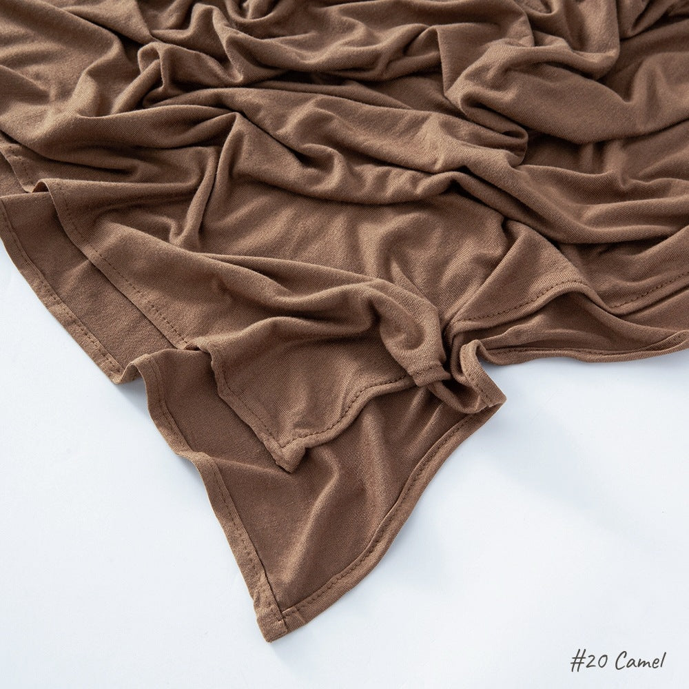 Close view of the plain knit modal cotton scarf showing its matte natural texture and soft drape