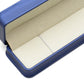Close up of an open navy crown clasp necklace box showing the padded grey interior