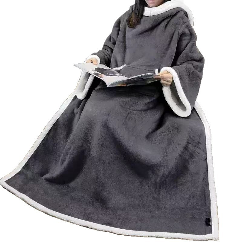 Dark grey wearable sleeve blanket with white sherpa cuffs and edge worn by a seated person on a white background
