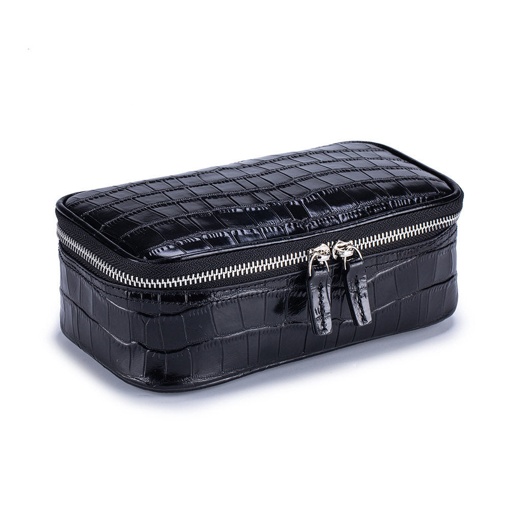 Black crocodile pattern genuine leather cosmetic bag with silver double zipper, three quarter view