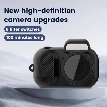 Rounded black mini digital camera with a lens dial and a small flash window