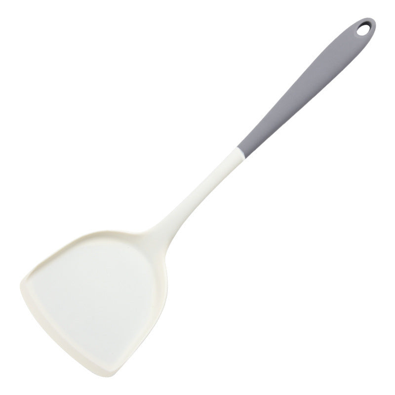 Gray and white silicone turner with a wide flat head and a hanging hole on white