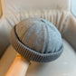 Black brimless dome beanie with a ribbed rolled cuff