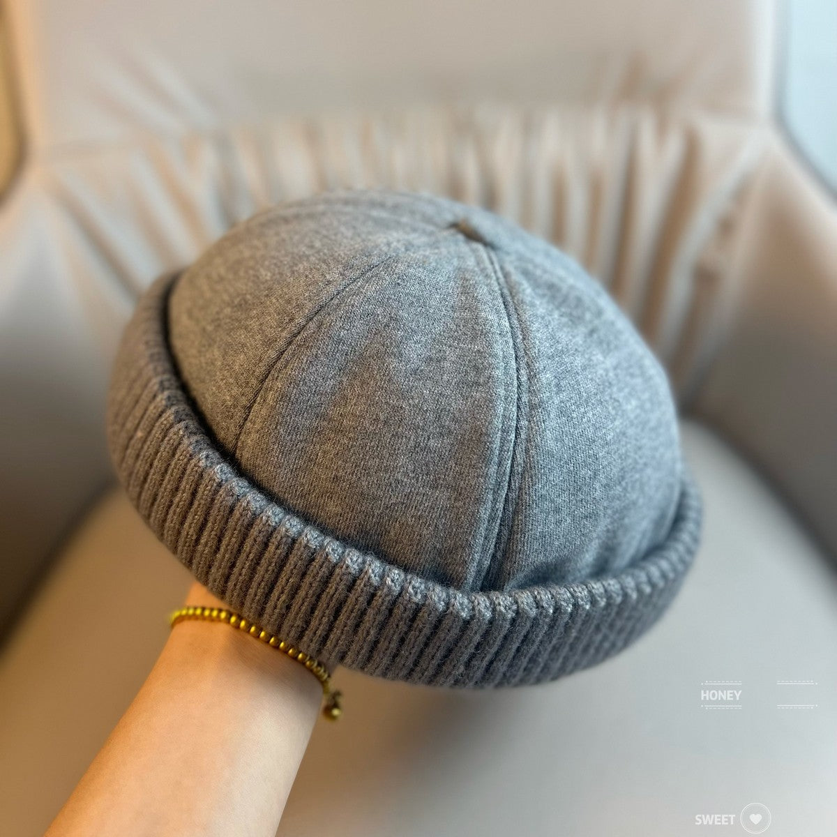 Black brimless dome beanie with a ribbed rolled cuff