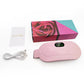 Pink heating belt beside a rose print box with a white USB cable and a thank you card