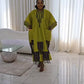 Chartreuse boubou kaftan dress of the same fringed color block design shown full length in a bright room