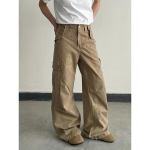 Khaki distressed loose-fit pants shown from the side, straight relaxed leg