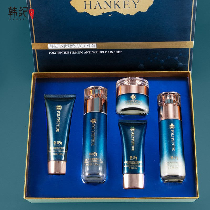 Open blue Hankey gift box holding a cleanser tube, two bottles, a cream jar and a BB cream tube in a fitted tray