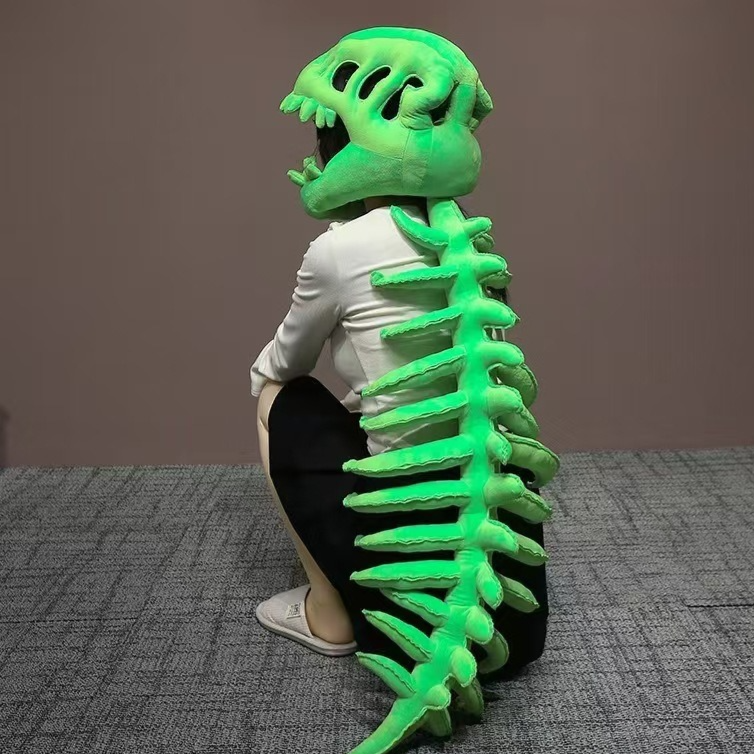 Person wearing a green plush dinosaur skeleton head mask with a bright green trailing spine