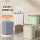 Gray, white, green and cream smart trash cans in a group on a beige shelf, with a smart sensing banner
