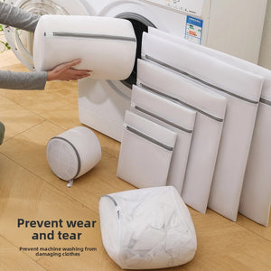 Light gray mesh laundry wash bags in several sizes shown beside a washing machine