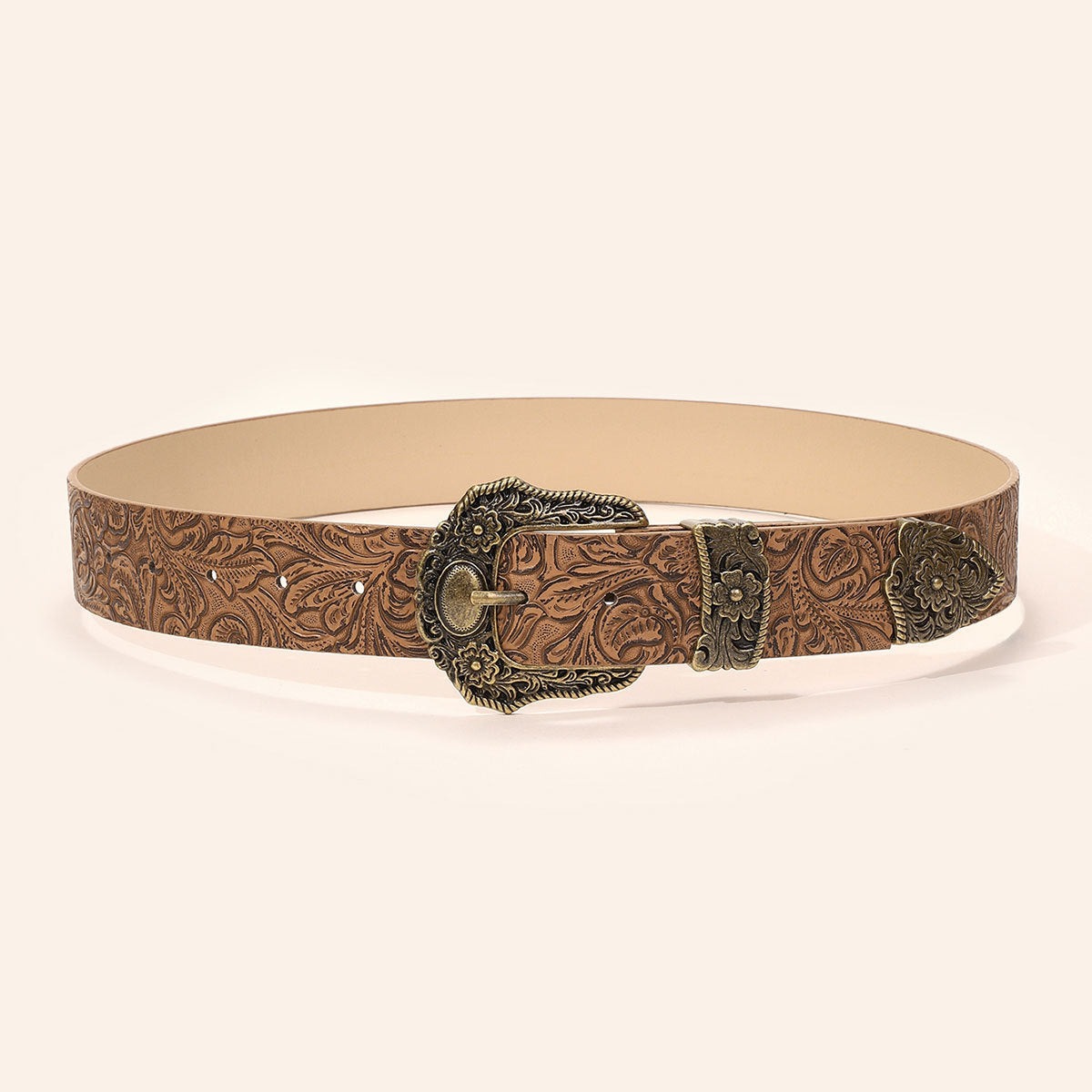 Close view of the ornate antique brass pin buckle on the floral tooled wide belt