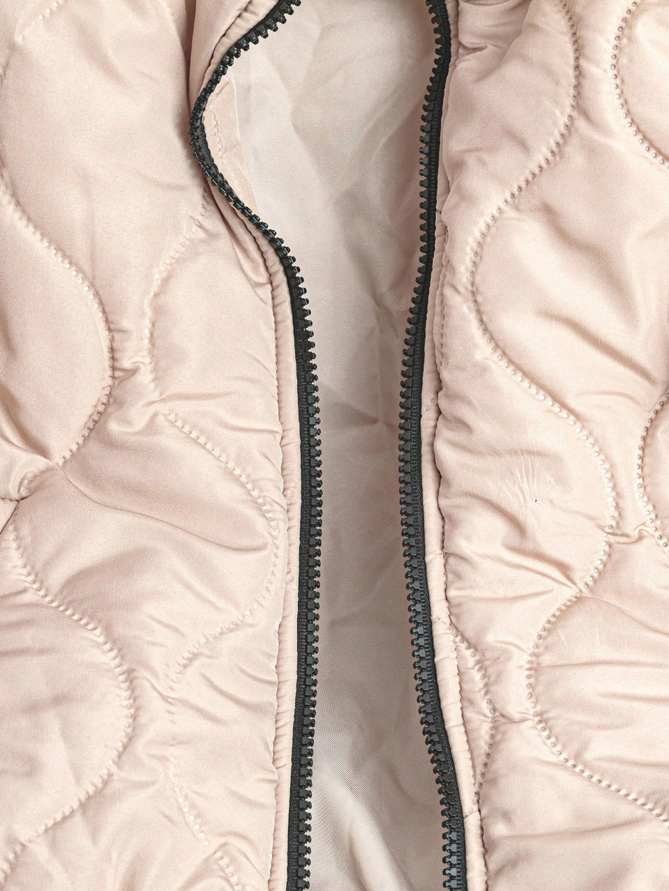 Khaki quilted bomber jacket showing the soft padded channel quilting and full zip