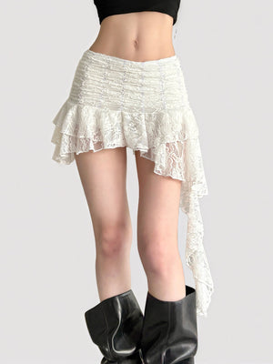 White lace tiered mini skirt worn low on the hips with a long asymmetric lace tail