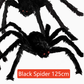 Hairy black Halloween spider prop with red eyes, flocked body and eight posable bendable legs