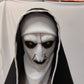 Open mouth horror nun mask showing jagged teeth under a black and white veil
