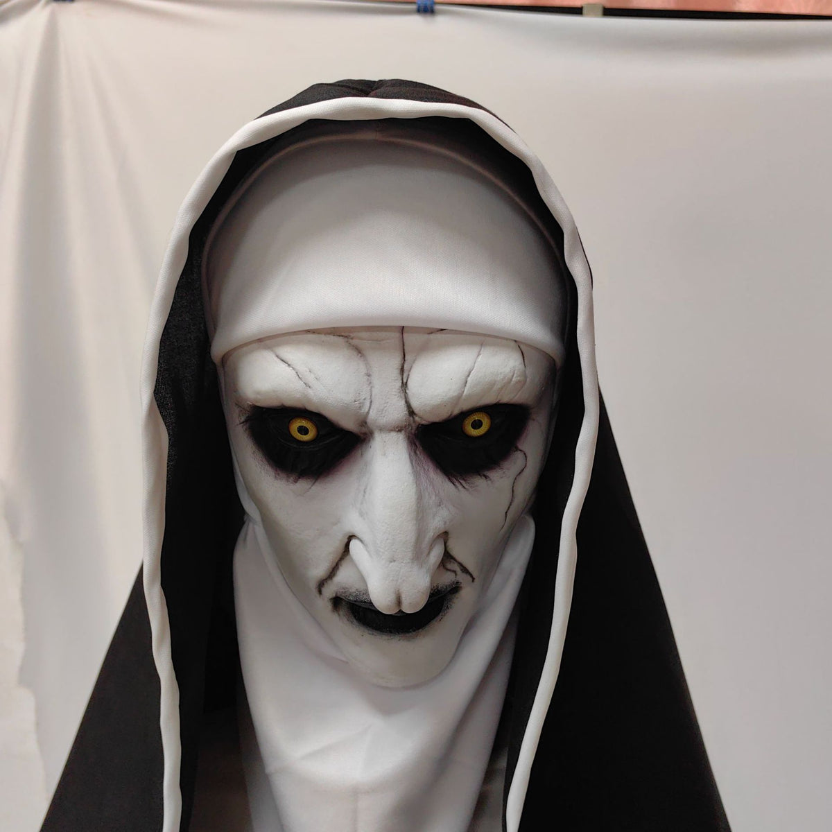 Open mouth horror nun mask showing jagged teeth under a black and white veil