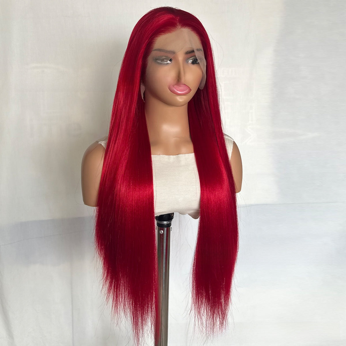 Long straight Neptune red synthetic wig with center part and lace hairline on a mannequin