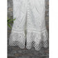 Detail of scalloped eyelet ruffle hem on the white lace short dress