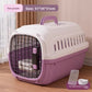 Cat resting inside the hard plastic travel crate behind the open wire grille door