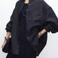 Relaxed fit linen shirt worn buttoned over trousers with dropped shoulders