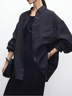 Relaxed fit linen shirt worn buttoned over trousers with dropped shoulders