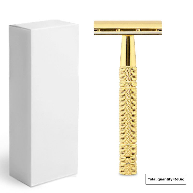 Gold double edge safety razor beside plain white retail packaging box