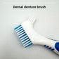 Close up of a blue denture brush showing the wide bristle head and the small tapered head on one handle