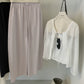 Lilac cotton wide leg trousers hung beside a sheer white shirt