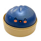 Pearly steamed bun squishy toy resting in its small dish on a plain background